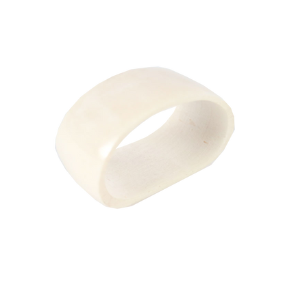 Bone napkin ring with ivory-like finish, handcrafted decor piece.